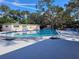 Community pool with lounge chairs and a clear blue sky at 2587 Blackwood Cir, Clearwater, FL 33763