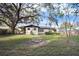 Spacious backyard featuring a fire pit and large oak tree at 5818 18Th S Ave, Gulfport, FL 33707
