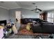 Open-concept living room featuring a large gray sectional, neutral paint, and wood-look flooring at 583 Portside Dr, North Port, FL 34287