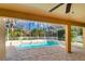 Screened-in pool area with brick pavers and covered patio at 8823 Wavyedge Ct, Trinity, FL 34655