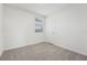 Well-lit bedroom with neutral carpeting and window with blinds at 3622 Moscato Dr, Brooksville, FL 34602