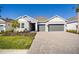 One-story home with gray two-car garage and landscaped front yard at 1564 Laurel Brook Ln, Port Charlotte, FL 33953