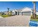 Two-car garage home with paver driveway and landscaping at 1564 Laurel Brook Ln, Port Charlotte, FL 33953