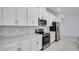 Modern kitchen with white cabinets, stainless steel appliances, and quartz countertops at 1564 Laurel Brook Ln, Port Charlotte, FL 33953