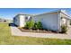 Home's side elevation showcasing landscaping and walkway at 16093 Ivy Ridge Ct, Port Charlotte, FL 33953