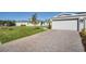 Attractive paver driveway and well-manicured lawn at 16093 Ivy Ridge Ct, Port Charlotte, FL 33953