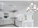 Modern white kitchen with island and stainless steel appliances at 16093 Ivy Ridge Ct, Port Charlotte, FL 33953