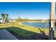 Peaceful backyard view of a lake and lush landscape at 16093 Ivy Ridge Ct, Port Charlotte, FL 33953