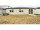 House backyard with sliding glass door access at 31650 Malbec Dr, Brooksville, FL 34602