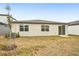 House backyard with sliding glass door access at 31650 Malbec Dr, Brooksville, FL 34602