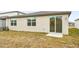 House backyard with sliding glass door access at 31650 Malbec Dr, Brooksville, FL 34602