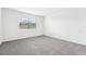 Spacious bedroom with grey carpet and window at 31650 Malbec Dr, Brooksville, FL 34602