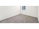 Spacious bedroom with grey carpet and large window at 31650 Malbec Dr, Brooksville, FL 34602