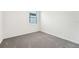 Simple bedroom with grey carpet and window at 31650 Malbec Dr, Brooksville, FL 34602