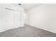 Bright bedroom with double doors and grey carpet at 31650 Malbec Dr, Brooksville, FL 34602