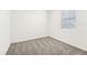 Simple bedroom with grey carpet and window with blinds at 31650 Malbec Dr, Brooksville, FL 34602