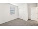 Spacious bedroom with grey carpet and double door closet at 31650 Malbec Dr, Brooksville, FL 34602