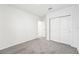 Well-lit bedroom featuring grey carpet and double doors at 31650 Malbec Dr, Brooksville, FL 34602