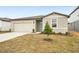 New construction home with a two-car garage and a small front yard at 31650 Malbec Dr, Brooksville, FL 34602