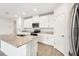 Modern kitchen with white cabinets and granite countertops at 31650 Malbec Dr, Brooksville, FL 34602
