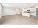 Open concept kitchen with white cabinets and granite countertops at 31650 Malbec Dr, Brooksville, FL 34602