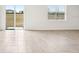 Bright and airy living area with tile floors and sliding glass doors at 31650 Malbec Dr, Brooksville, FL 34602