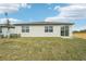 New home with grassy backyard and sliding glass door at 31698 Wild Grape Ln, Brooksville, FL 34602