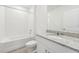 Clean bathroom with granite countertop vanity and tiled shower/tub at 31698 Wild Grape Ln, Brooksville, FL 34602