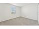 Cozy carpeted bedroom with window and neutral wall colors at 31698 Wild Grape Ln, Brooksville, FL 34602