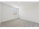 Well-lit bedroom featuring neutral wall paint and carpet flooring at 31698 Wild Grape Ln, Brooksville, FL 34602