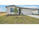 One-story home with a two-car garage and landscaped lawn at 31698 Wild Grape Ln, Brooksville, FL 34602