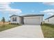 Single-story house with a two-car garage and a paved driveway at 31698 Wild Grape Ln, Brooksville, FL 34602