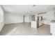 Open concept kitchen with island, stainless steel appliances, and grey tile floors at 31698 Wild Grape Ln, Brooksville, FL 34602