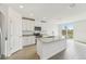 Modern kitchen with white cabinets, granite countertop island, and stainless steel appliances at 31698 Wild Grape Ln, Brooksville, FL 34602