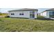 Home's backyard with grassy lawn at 31703 Wild Grape Ln, Brooksville, FL 34602