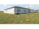 Home's backyard with grassy lawn at 31703 Wild Grape Ln, Brooksville, FL 34602