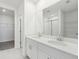 Double vanity bathroom with white cabinets and a walk-in shower at 31703 Wild Grape Ln, Brooksville, FL 34602