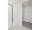 Bathroom with shower, walk-in closet, and gray carpeting at 31703 Wild Grape Ln, Brooksville, FL 34602