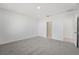 Bright bedroom with grey carpet and access to bathroom at 31703 Wild Grape Ln, Brooksville, FL 34602