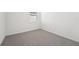 Bright bedroom with neutral carpeting and window at 31703 Wild Grape Ln, Brooksville, FL 34602