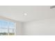 Bright and airy bedroom with large window and neutral walls at 31703 Wild Grape Ln, Brooksville, FL 34602