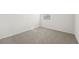 Empty bedroom with gray carpet and window at 31703 Wild Grape Ln, Brooksville, FL 34602