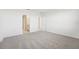 Well-lit bedroom featuring grey carpet and private bathroom access at 31703 Wild Grape Ln, Brooksville, FL 34602