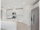Clean kitchen with white cabinets, stainless steel appliances, and a large island at 31703 Wild Grape Ln, Brooksville, FL 34602
