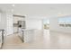 Open concept kitchen with island, stainless steel appliances, and white cabinetry at 31703 Wild Grape Ln, Brooksville, FL 34602