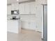 Modern kitchen with white cabinets and stainless steel appliances at 31703 Wild Grape Ln, Brooksville, FL 34602