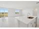 Open concept kitchen with island, stainless steel appliances, and white cabinetry at 31703 Wild Grape Ln, Brooksville, FL 34602