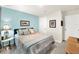 Bedroom with light blue accent wall and a queen bed at 7729 Rosewood Garden Loop, Tampa, FL 33637