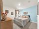 Light blue bedroom with a queen-size bed and dresser at 7729 Rosewood Garden Loop, Tampa, FL 33637
