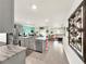 Modern kitchen with gray cabinets, an island, and view of living room at 7729 Rosewood Garden Loop, Tampa, FL 33637